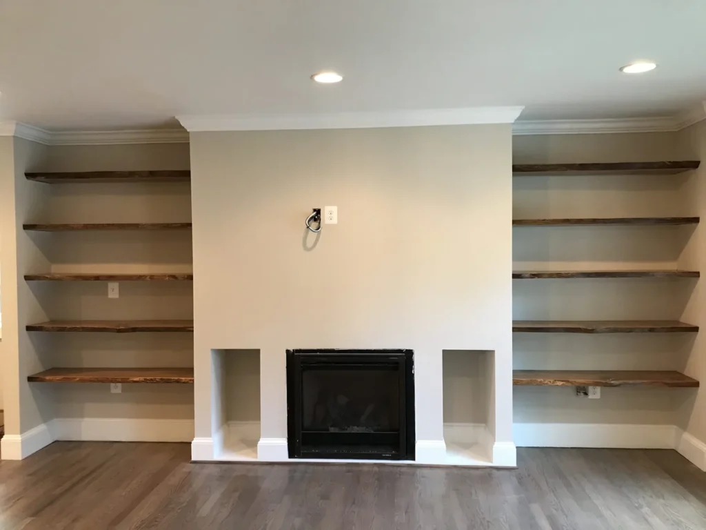 Fireplace wall flanked by live-edge wood shelves in a new addition