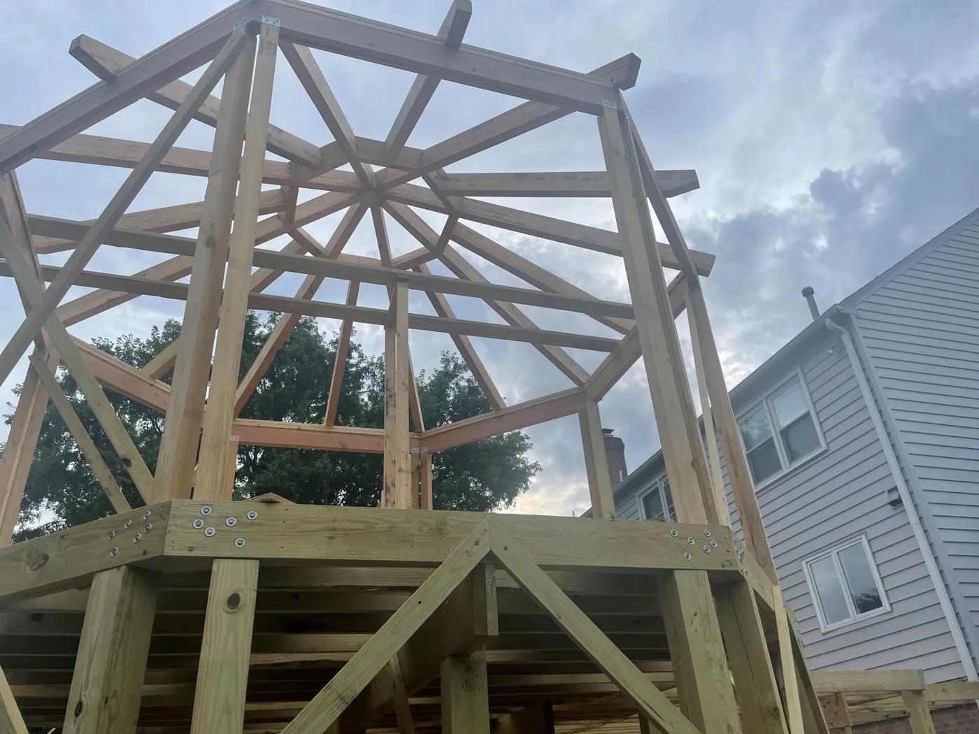 Octagonal gazebo roof and floor framing on an elevated deck during construction