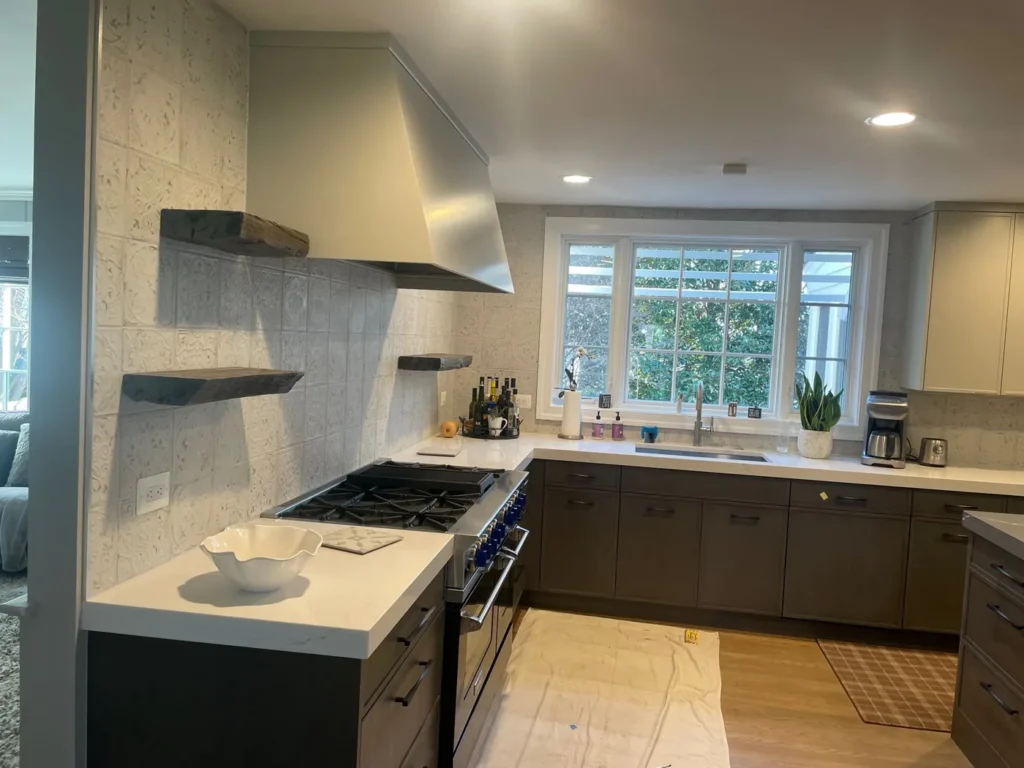 Remodeled kitchen with gray flat-panel cabinets, a professional range and floating shelves