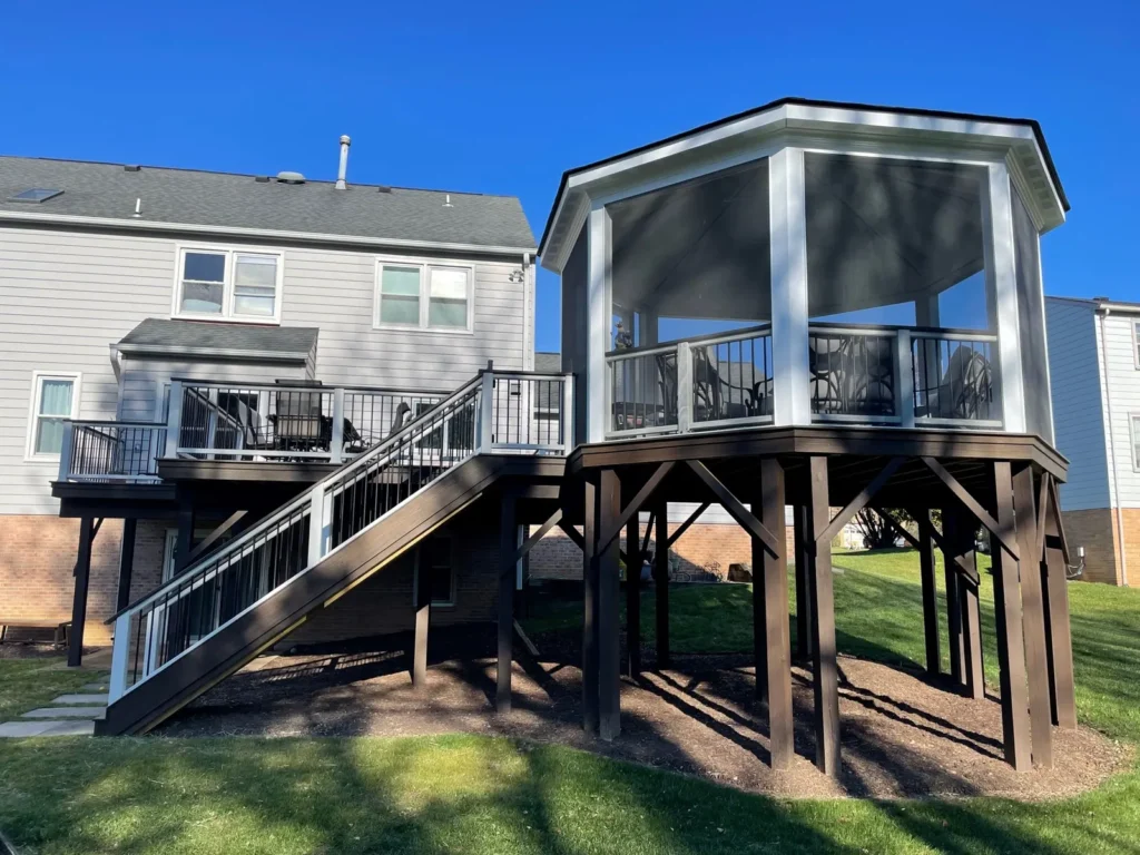 Elevated deck with stairs and a white screened octagonal gazebo, built by Reyes Construction Group