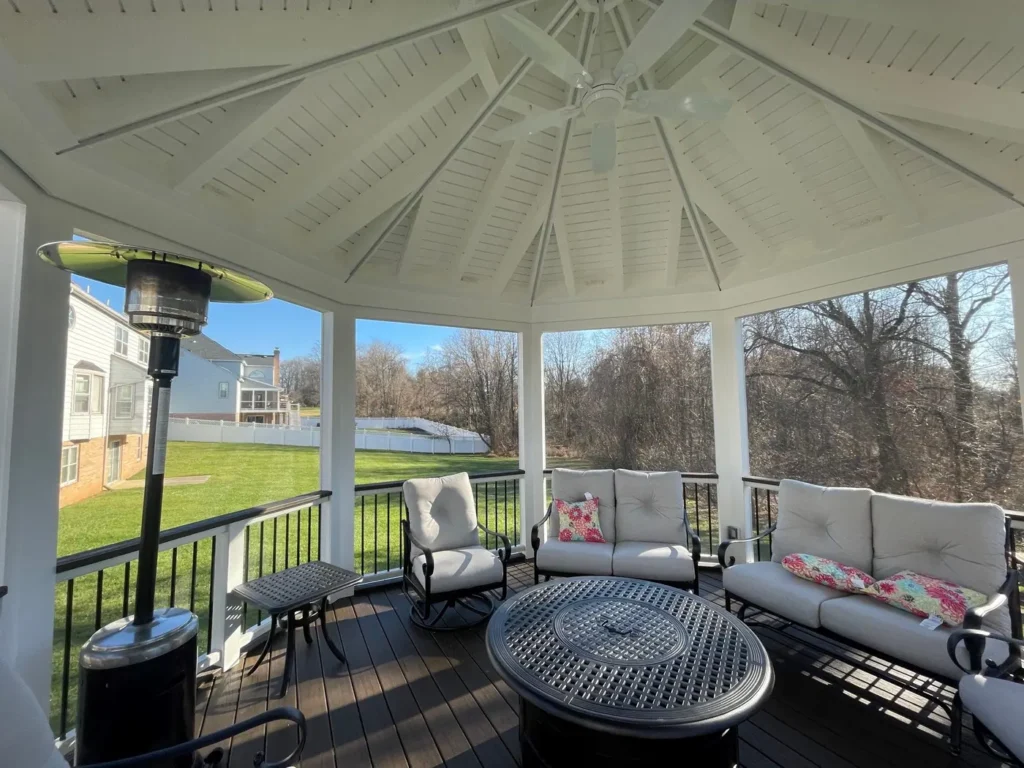 Furnished screened gazebo with a patio heater and a view of the yard