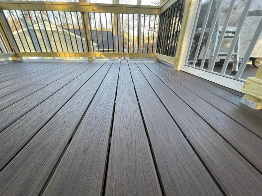 New composite deck boards with black metal balusters and white posts